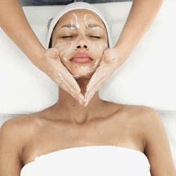 Woman getting facial cleanse done in facial treatment